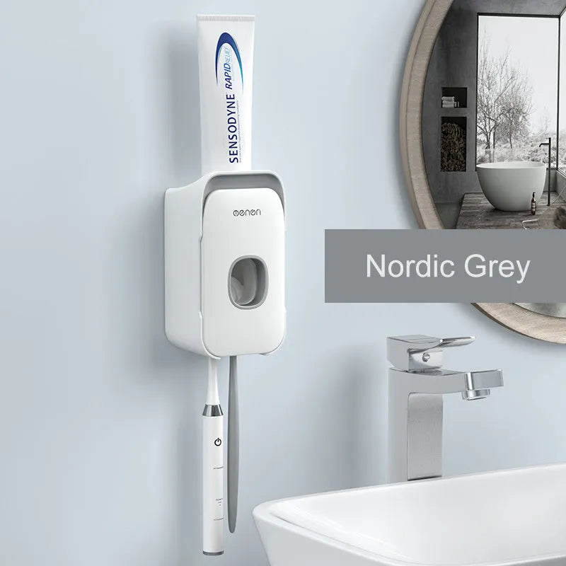 Automatic toothpaste dispenser in ABS plastic with suction cup wall mount in blue, grey, and pink colour options