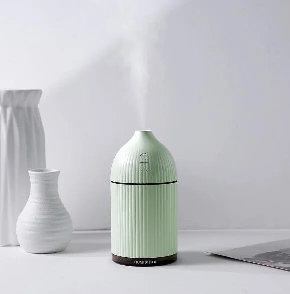 White cylindrical ultrasonic aromatherapy diffuser with LED light and 300ml water capacity.