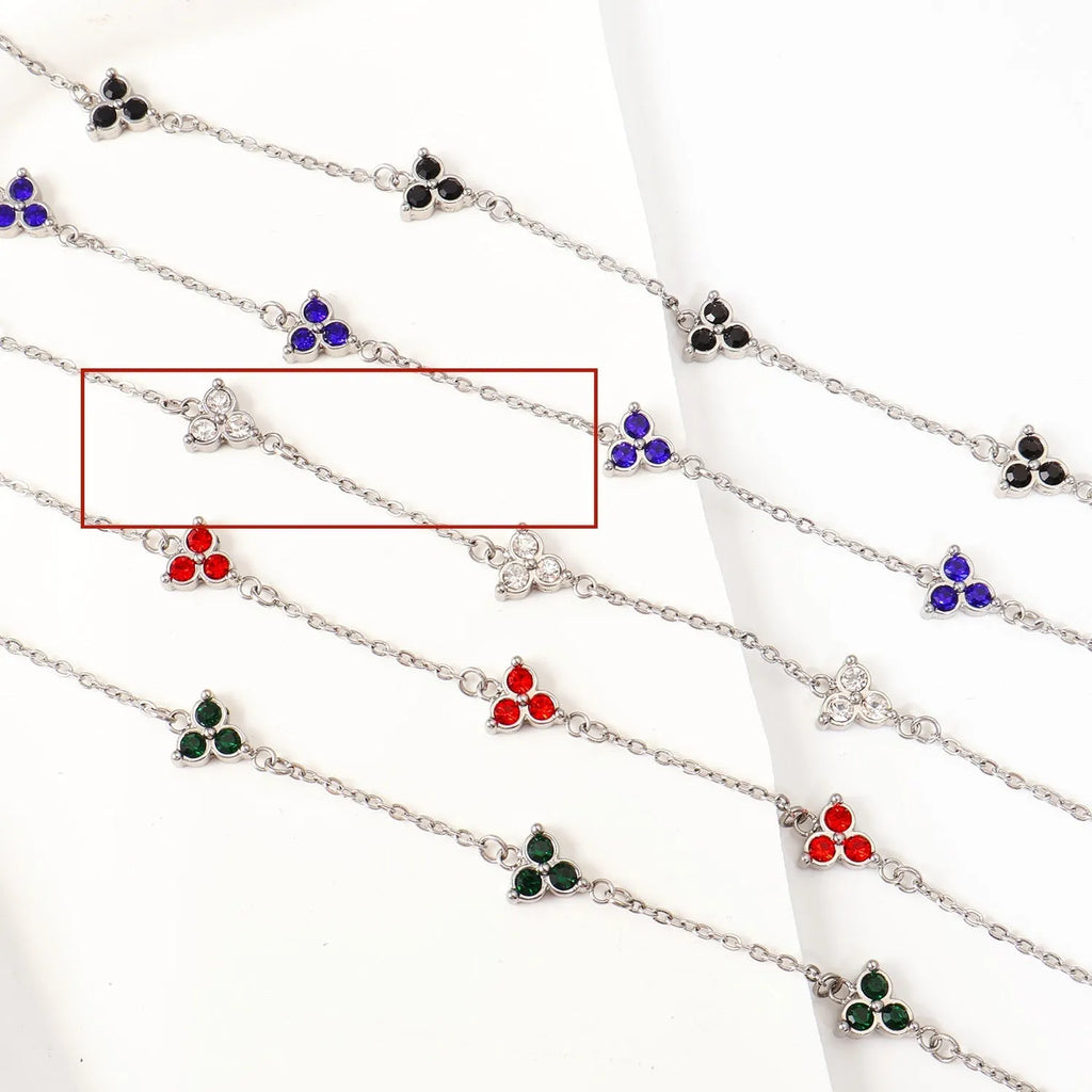 Women's stainless steel geometric bracelet with triangle design and coloured zircon stones.
