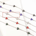 Women's stainless steel geometric bracelet with triangle design and coloured zircon stones.