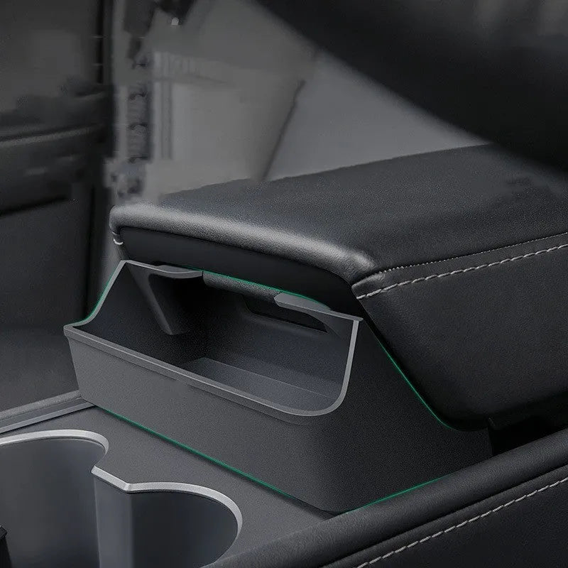 Black silicone sunglasses case mounted in Tesla centre console armrest compartment