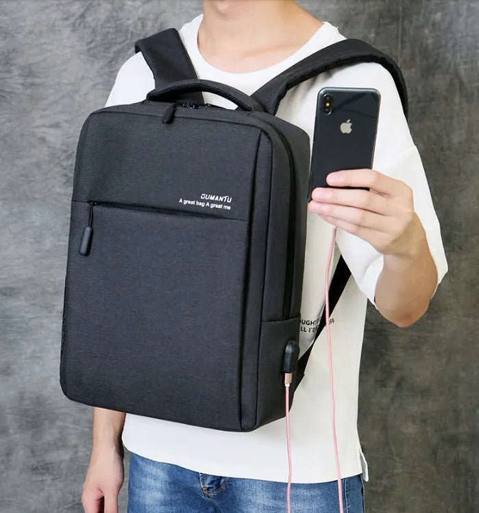 Waterproof Oxford cloth laptop backpack with rechargeable battery in black colour on a shoulder