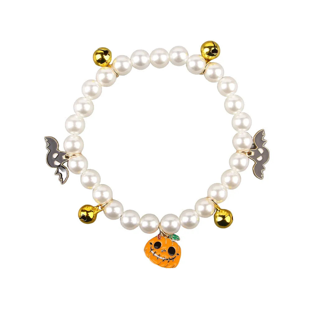 Halloween decorative pet collar with simulated pearls and a pumpkin charm.