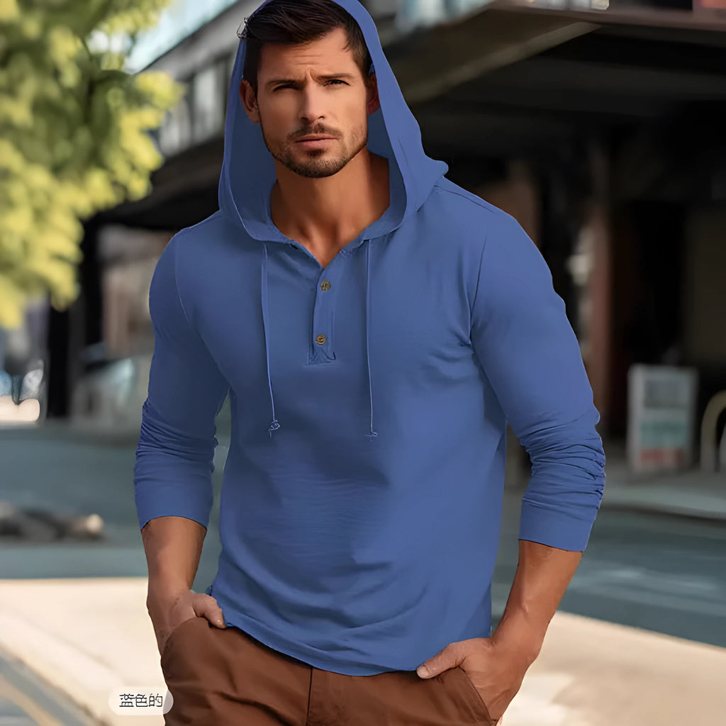 Man wearing a dark blue cotton pullover hoodie top with long sleeves, showing loose casual fit.