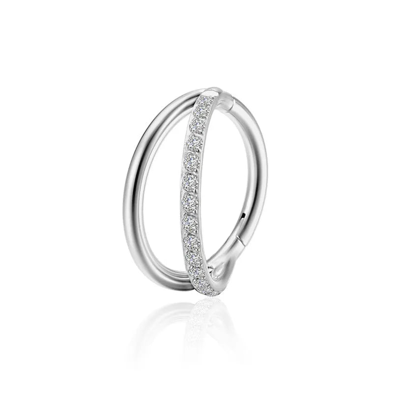 Titanium alloy nose ring jewellery on a plain background showing silver and gold colour options.