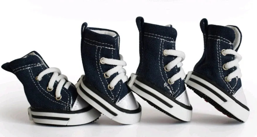 Navy blue denim canvas dog shoe with non-slip sole on a dog