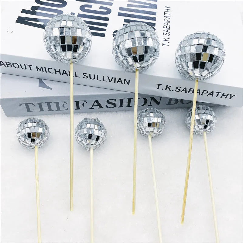 Glass mirror ball cake decoration on a wooden stick, available in four different sizes.
