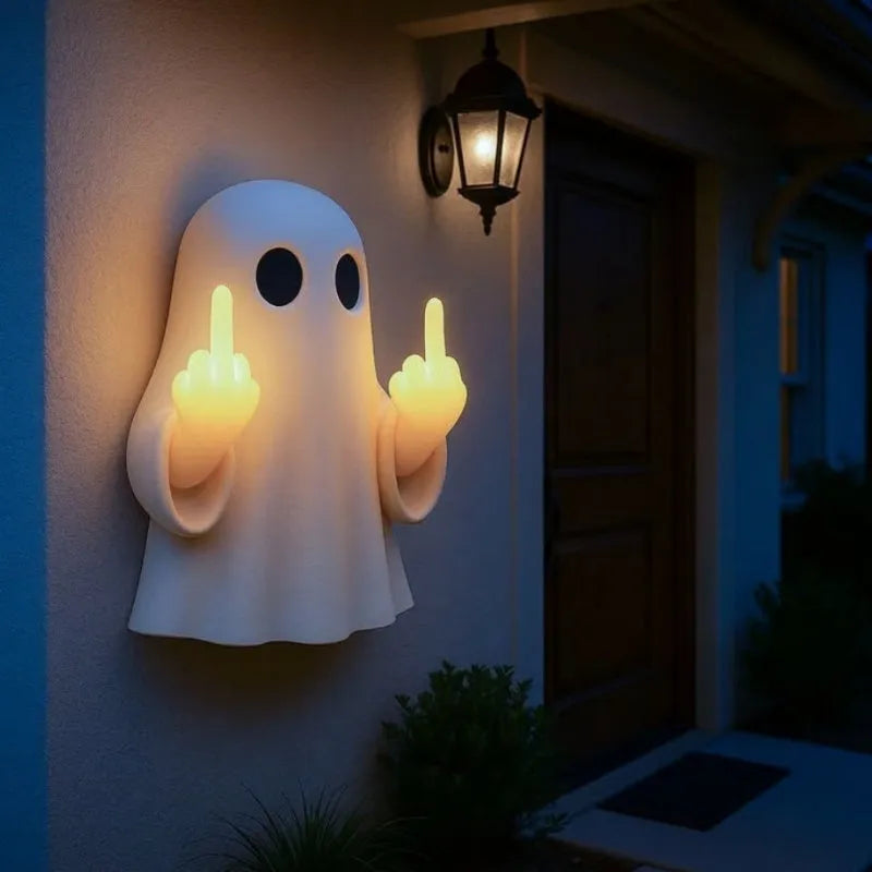 Small white ghost-shaped plastic night lamp for Halloween decoration on a table.