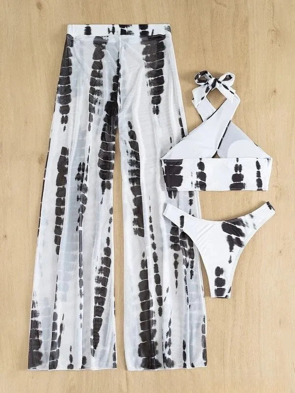 Women's black printed three-piece swimsuit set showing top, bikini bottoms, and mesh trousers.