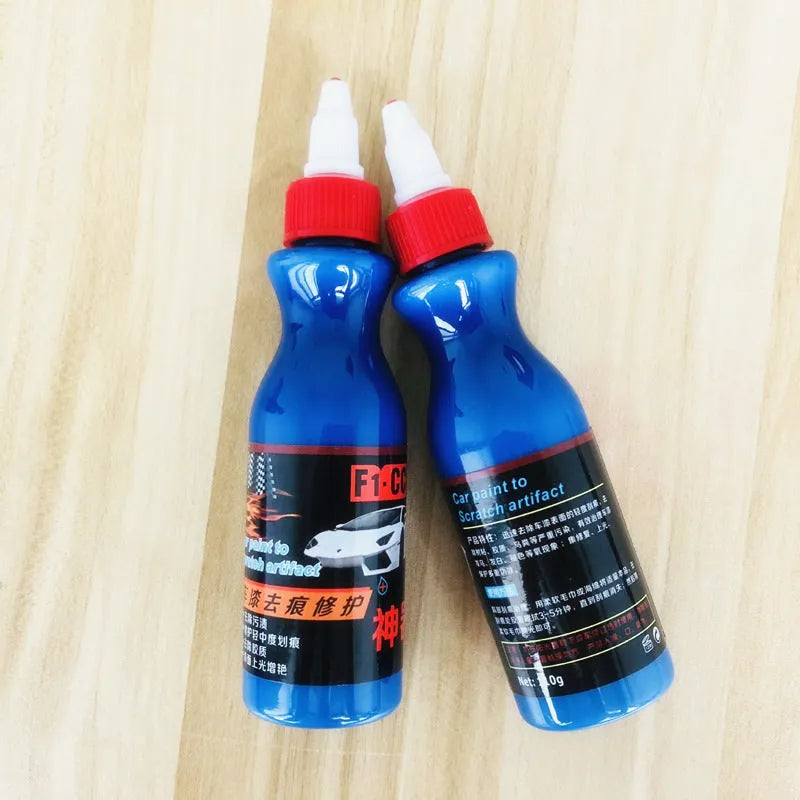 Small blue car wiping tool and bottle of scratch repair agent for DIY automotive scratch removal.