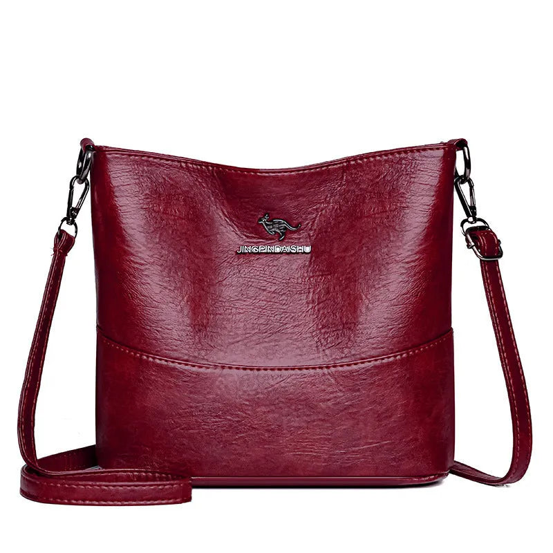 Women's black bucket-style leather shoulder bag with sewing line detailing and shoulder strap