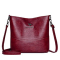 Women's black bucket-style leather shoulder bag with sewing line detailing and shoulder strap
