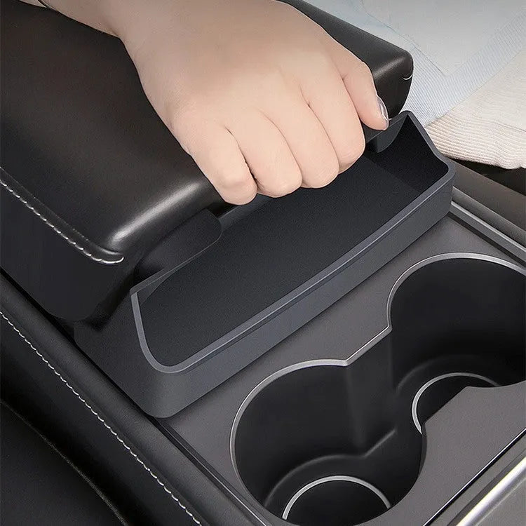Black silicone sunglasses case mounted in Tesla centre console armrest compartment