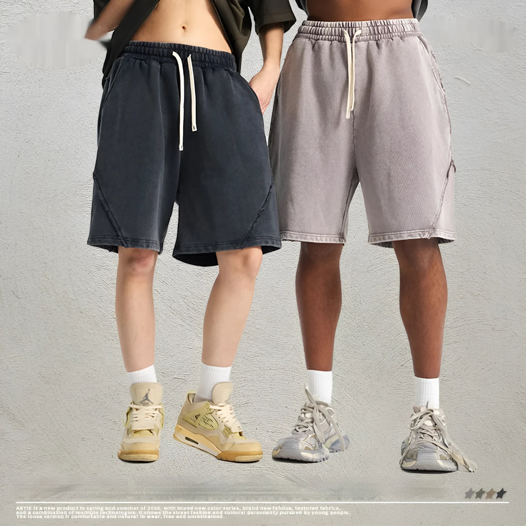 Man wearing retro-style batik washed grey-green cotton terry shorts with a loose fit.