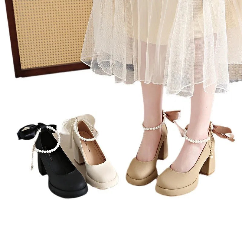 Beige women's Mary Jane shoes with a chunky heel and an ankle-strap buckle on a white background.