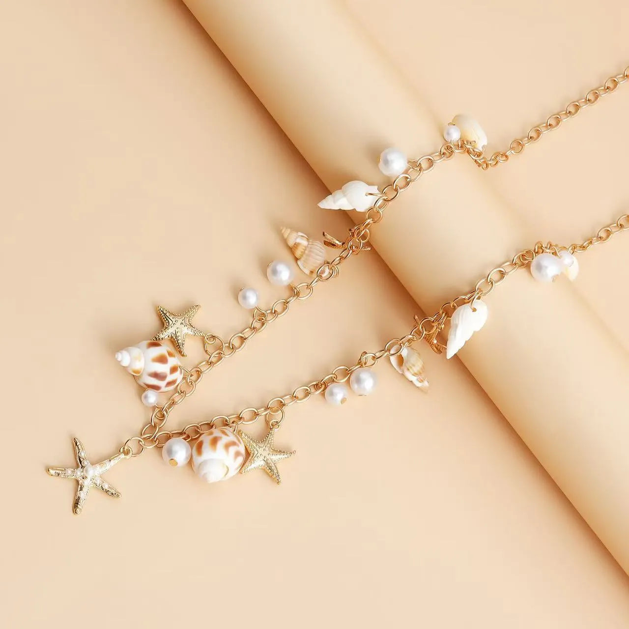 Women's alloy waist chain and matching bracelet set with star charms.