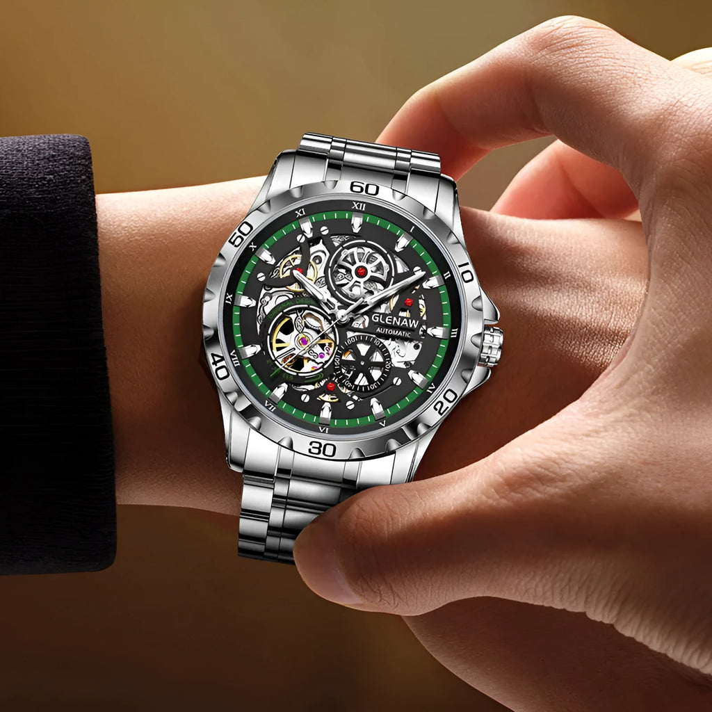 Silver men's automatic watch with hollow-out dial, luminous hands, and stainless steel strap.