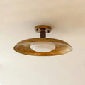 American retro alloy ceiling lamp in copper finish mounted on a ceiling.