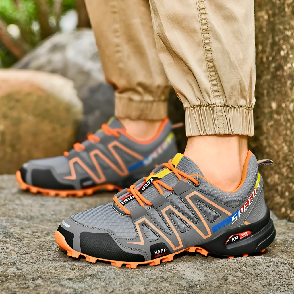 Men's grey orange and black white wide fit casual running shoes with low top design.