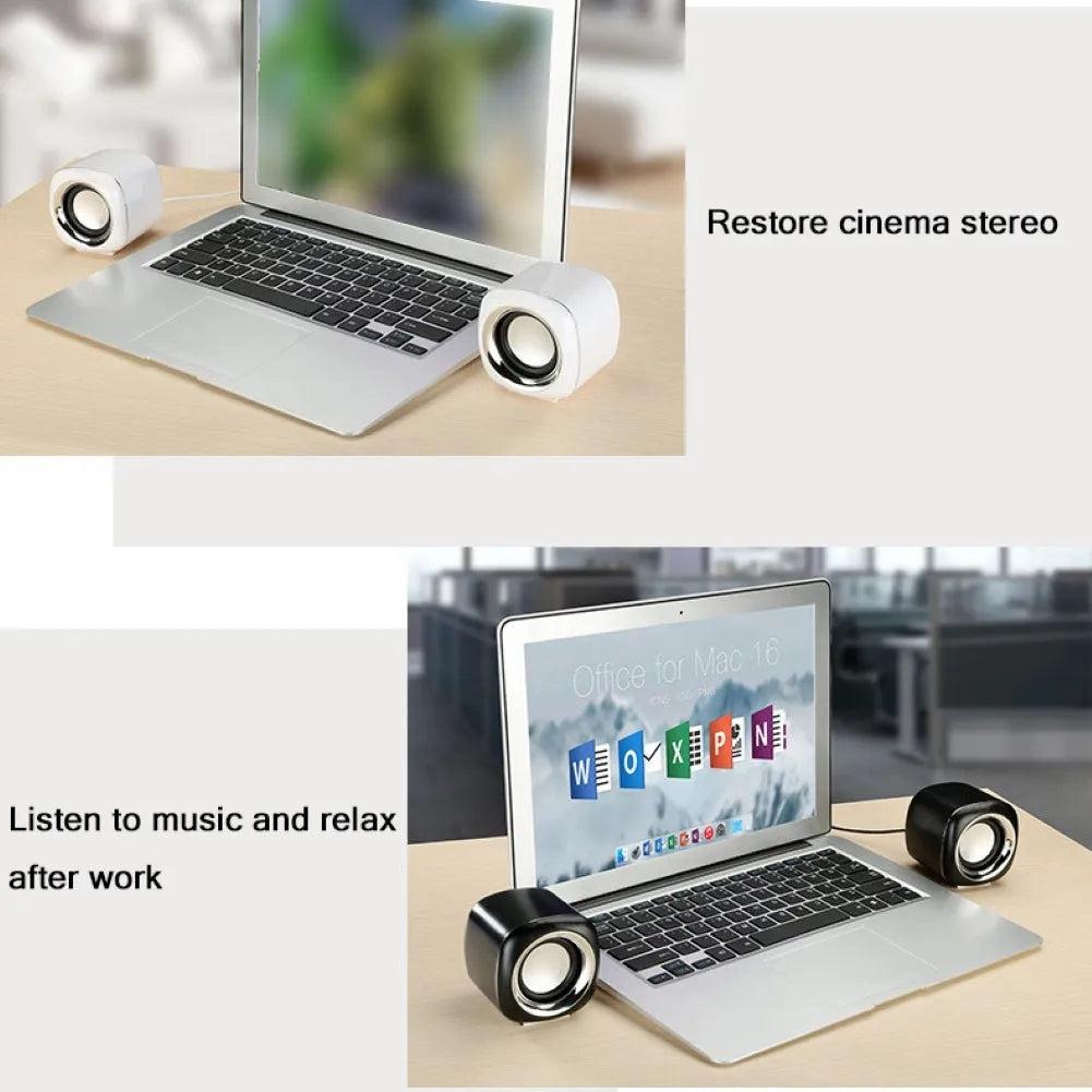 A pair of compact black or white wired desktop computer speakers with a volume scroll wheel.