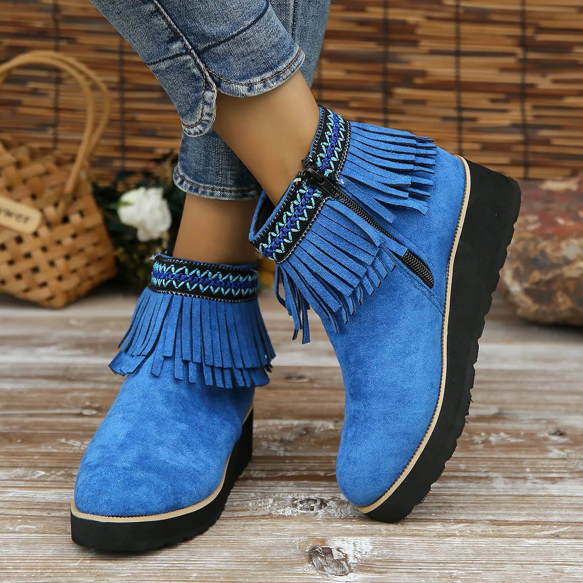 Women's dark brown suede wedge ankle boot with side zipper and tassel detail on a thick rubber sole.