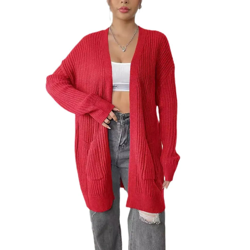 Womans loose fit acrylic cardigan sweater in dark green, showing mid-length and long sleeves.