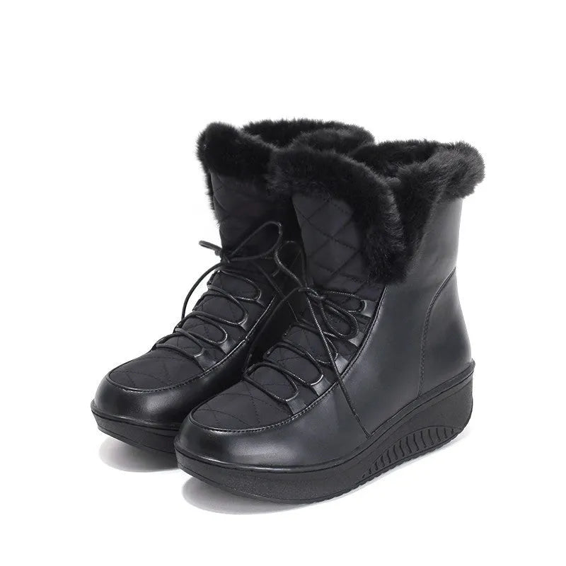 Women's black lace-up winter boots with a platform sole on a neutral background.
