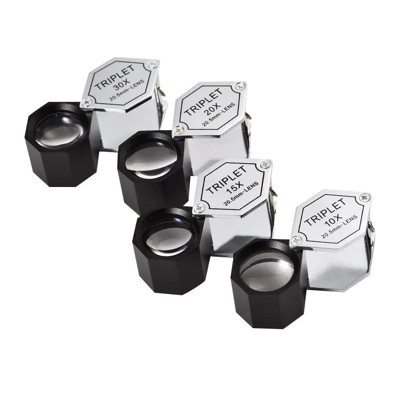 Handheld metal magnifying glass with optical glass lens for jewellery and stamp inspection.
