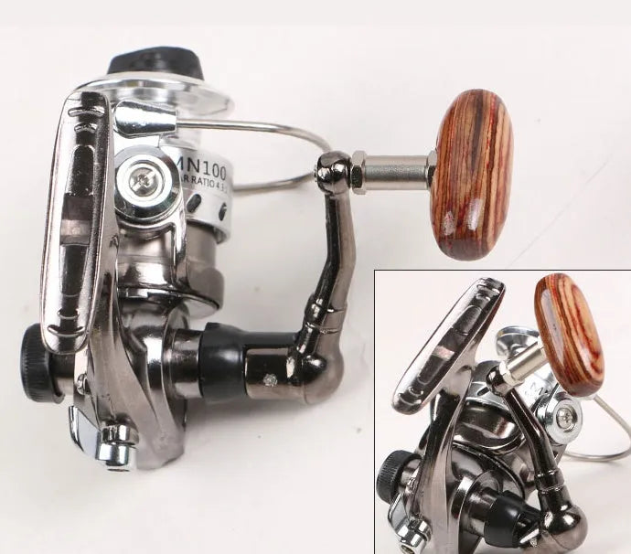 Mini 100 all metal black fishing reel with folding wooden rocker arm on white background