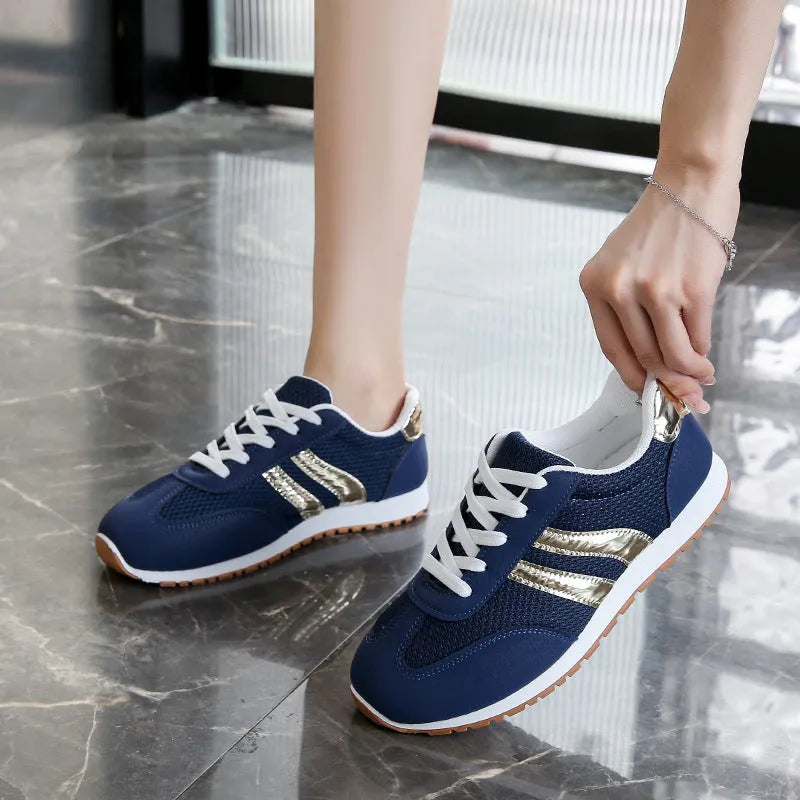 Blue women's casual tennis shoes with cross shoulder straps and white rubber sole.