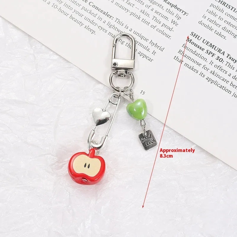 Coloured plastic fruit phone charms with rope attachments including apple and strawberry designs