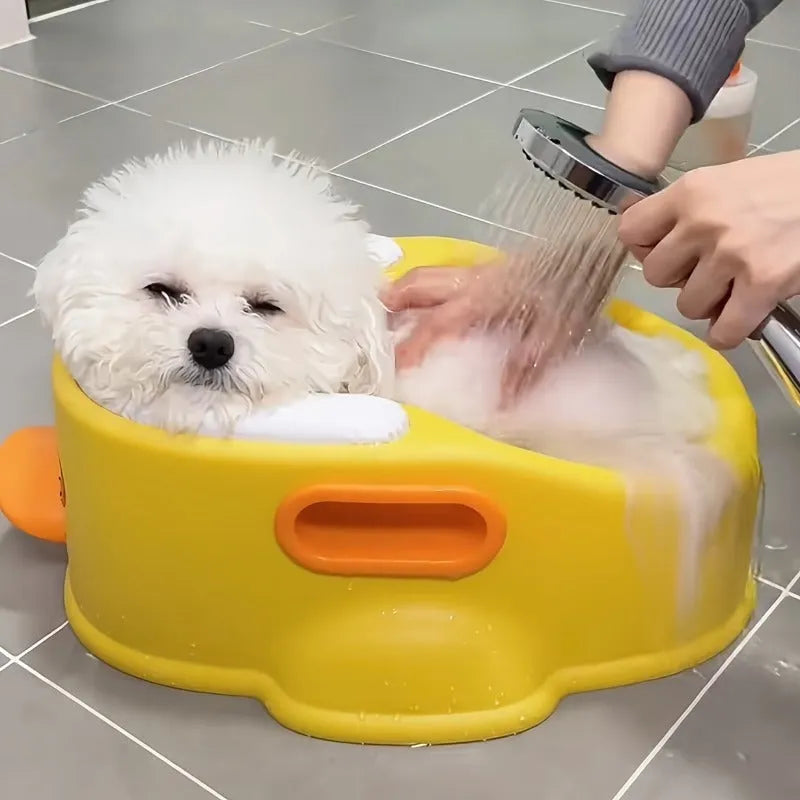 Blue PVC duck-shaped bathtub for washing a dog or cat at home.