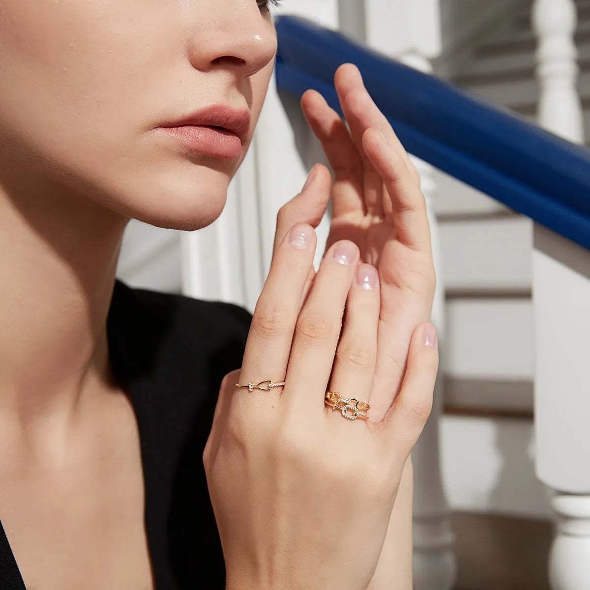 Gold electroplated silver bow ring with inlaid zirconium for women on plain background