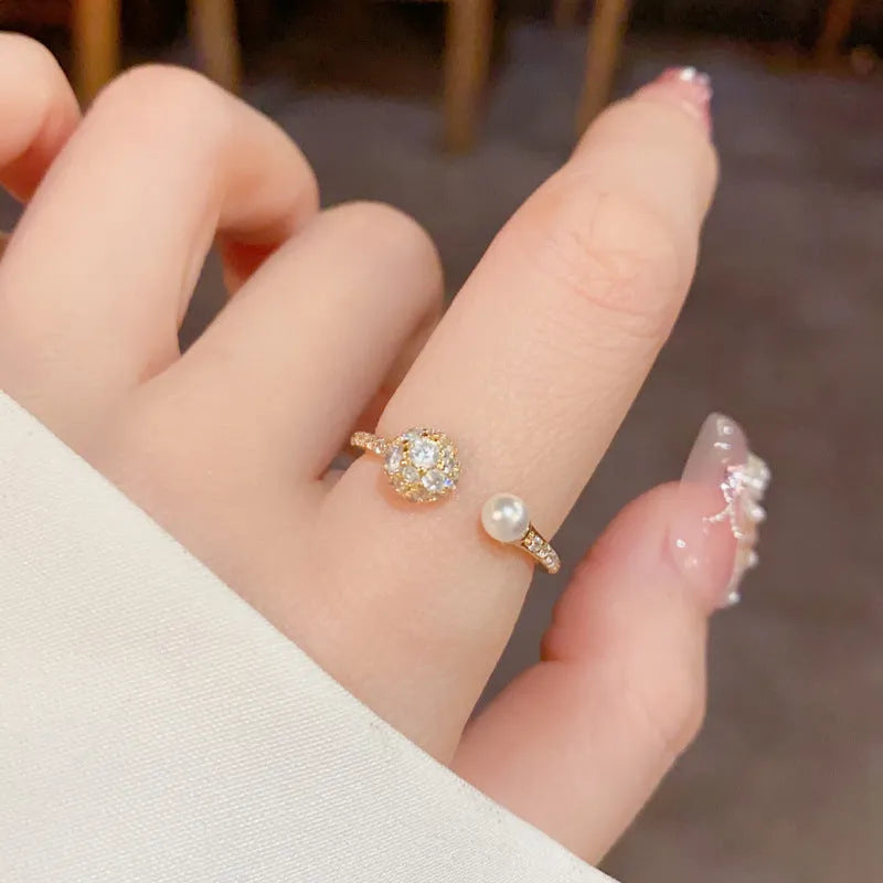 Open-end women's ring with round zircon and pearl elements in gold or silver real gold plating