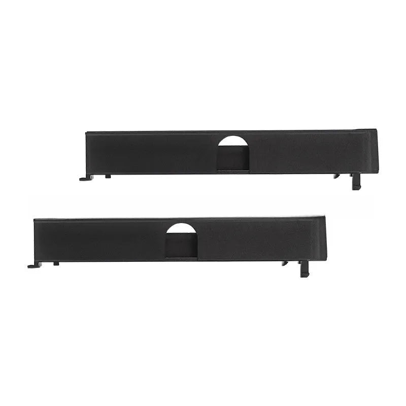 Black PS4 Pro hard drive bottom cover and small plastic repair parts including a baffle and strip.