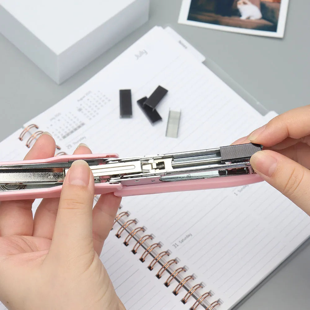A box of 1000 metal office staples in colours black, purple, rose gold, and rose red.