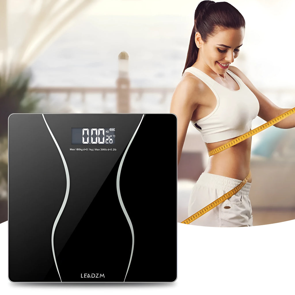 Black electronic digital bathroom scale with a digital display, shown on a bathroom floor.