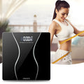 Black electronic digital bathroom scale with a digital display, shown on a bathroom floor.