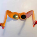 Orange plastic novelty sunglasses with a leg and hip design on the frame