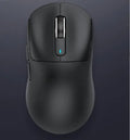 Black rechargeable Bluetooth mouse with USB receiver and charging cable on a wooden desk