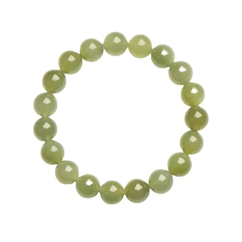 Polished Hetian jade ball bracelet in ice clear colour on a wrist, showing spherical beads.