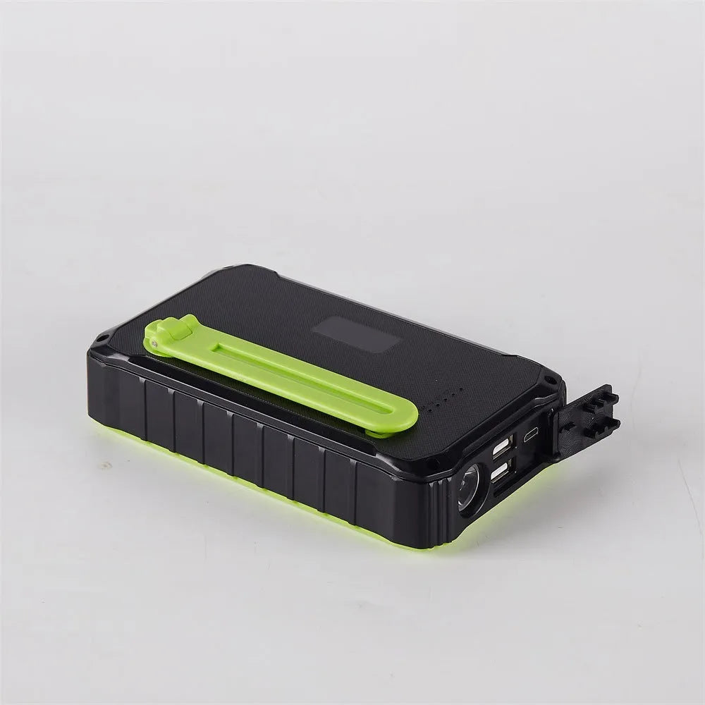 Orange and green hand crank solar power bank with 12000mAh capacity showing USB ports and LED torch