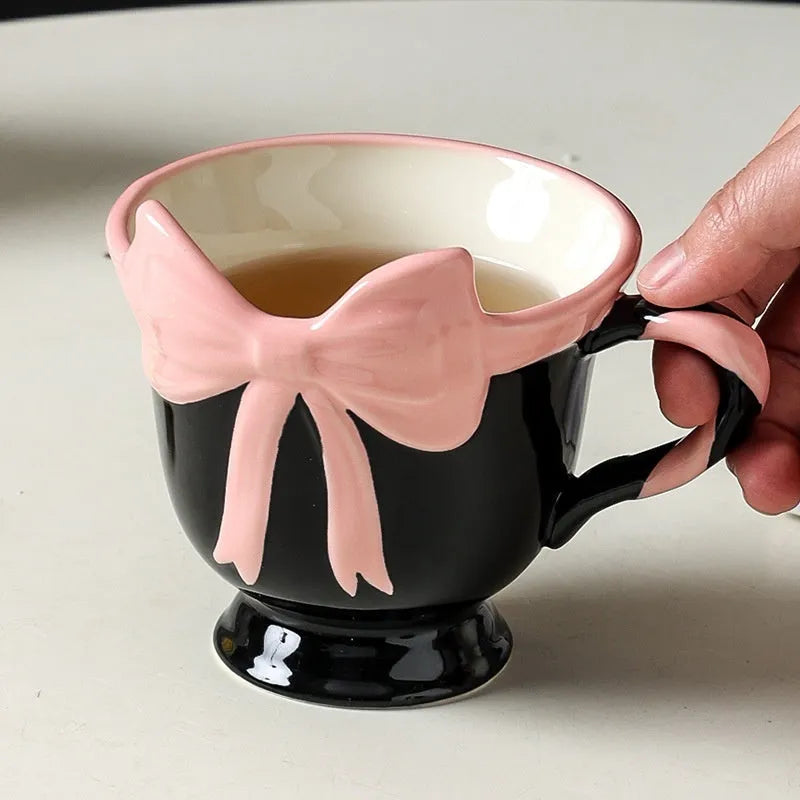 Ceramic mug with heart and bow design in Black Pink colour, showing 301-400ml capacity.