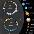 Two natural stone beaded bracelets showing different zodiac sign designs on a table.