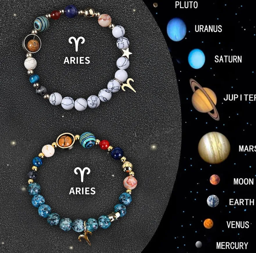Two natural stone beaded bracelets showing different zodiac sign designs on a table.