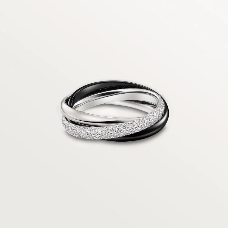 Set of three geometric U-shaped silver couple rings with diamond accents on a grey background.