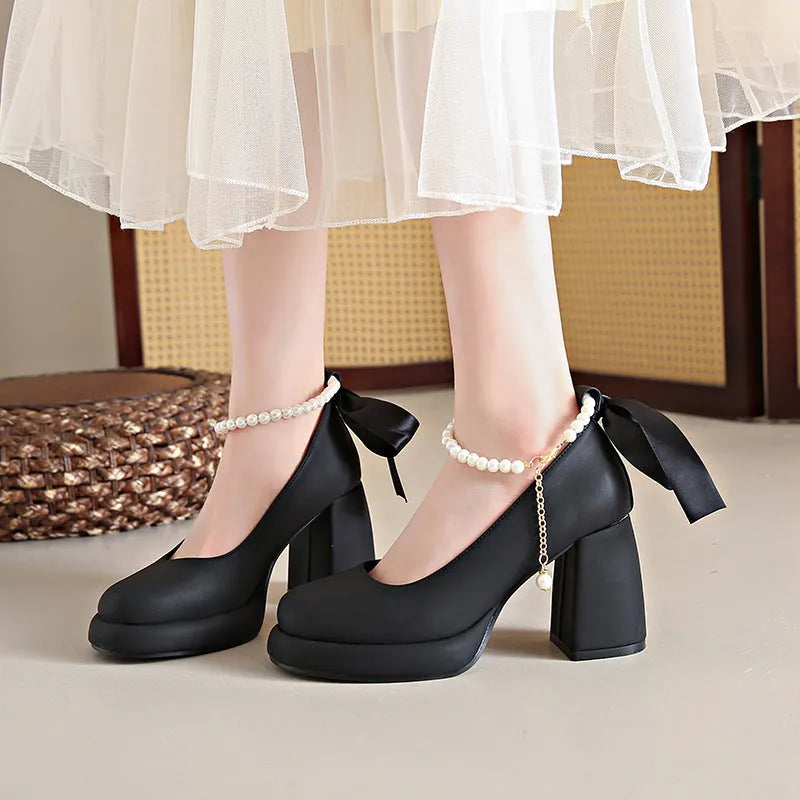 Beige women's Mary Jane shoes with a chunky heel and an ankle-strap buckle on a white background.