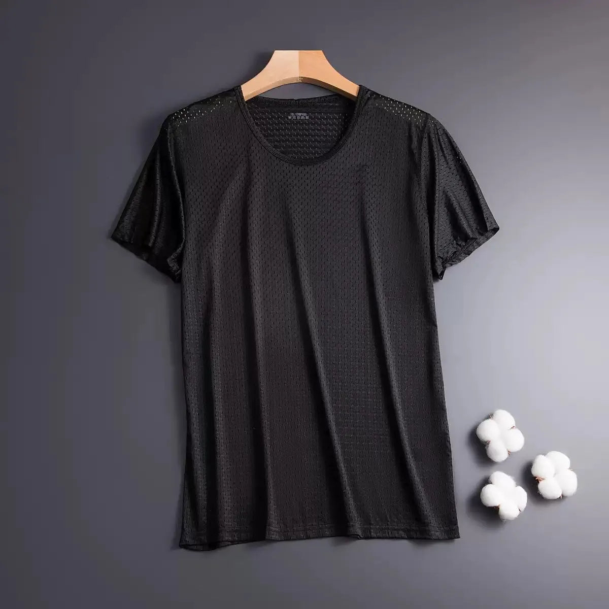 Man wearing a loose-fit grey ice silk short sleeve t-shirt on a summer day.