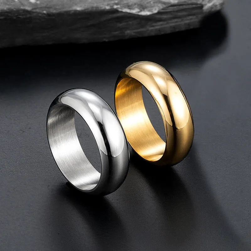 Glossy electroplated titanium steel ring in gold, black and steel colours showing detailed finish