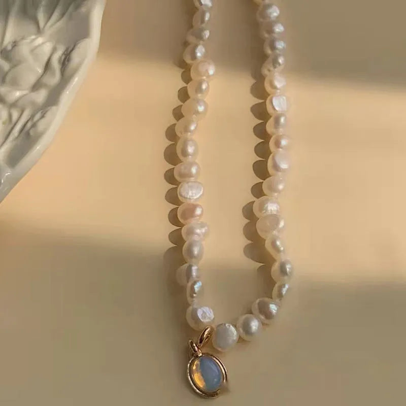 Adjustable French court vintage style pearl necklace with geometric design on a model.